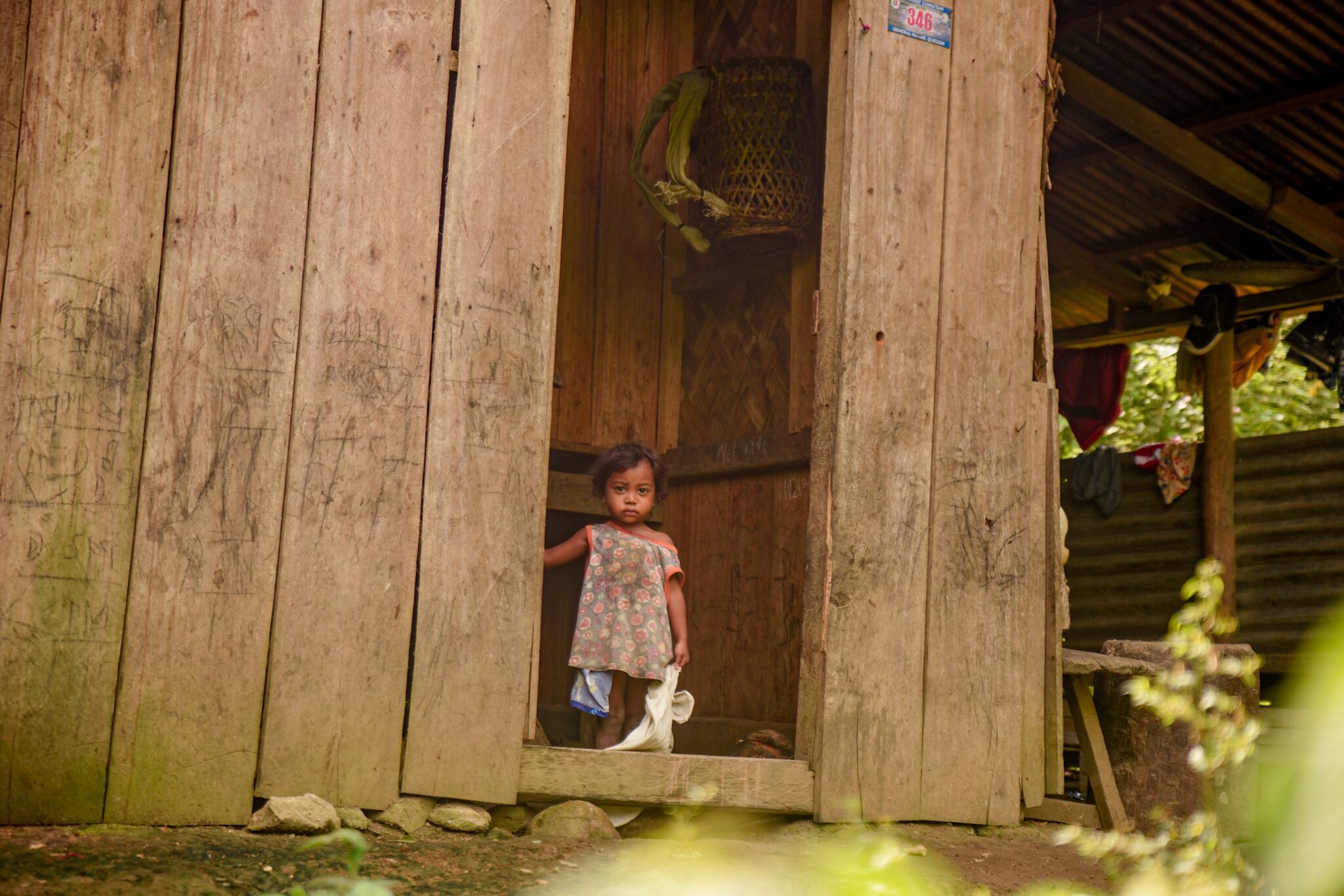 Children looking at Planet Water team from her house